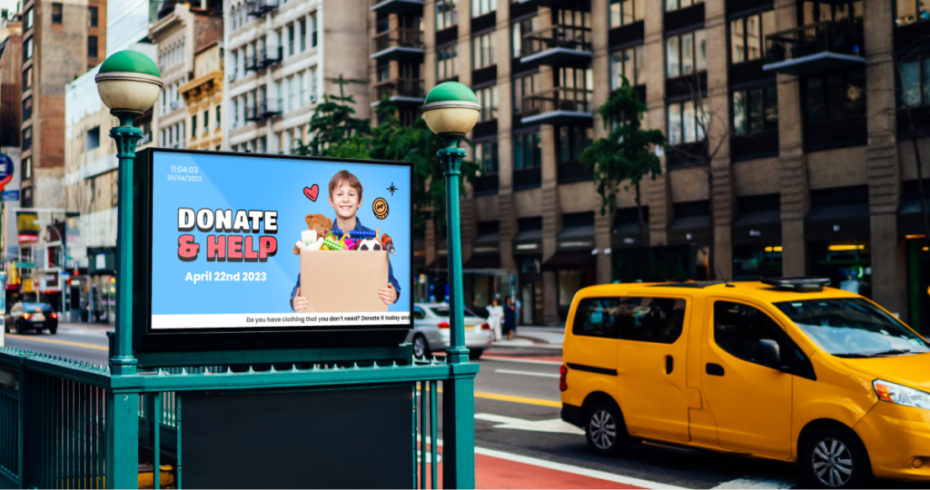 image of a street, showing a red van crossing and a digital signage screen showcasing a nonprofit message.